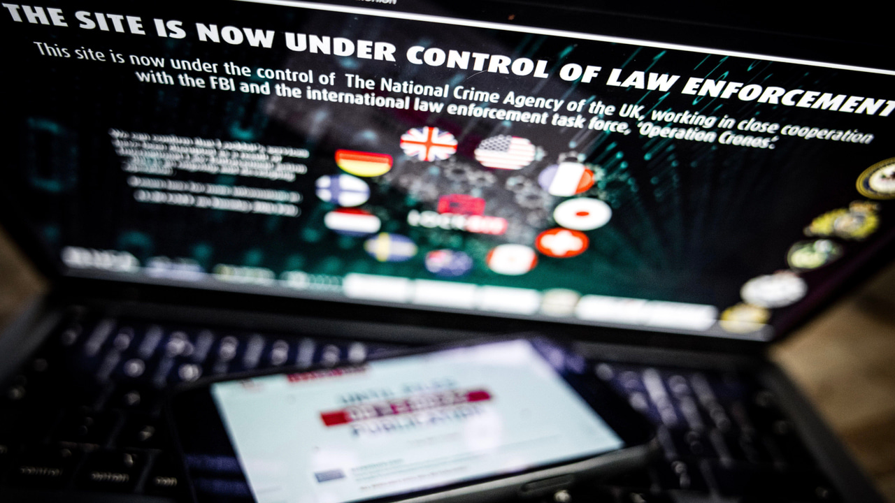 A mobile phone with the Lockbit website placed on a computer keyboard with the seized leak site on the screen